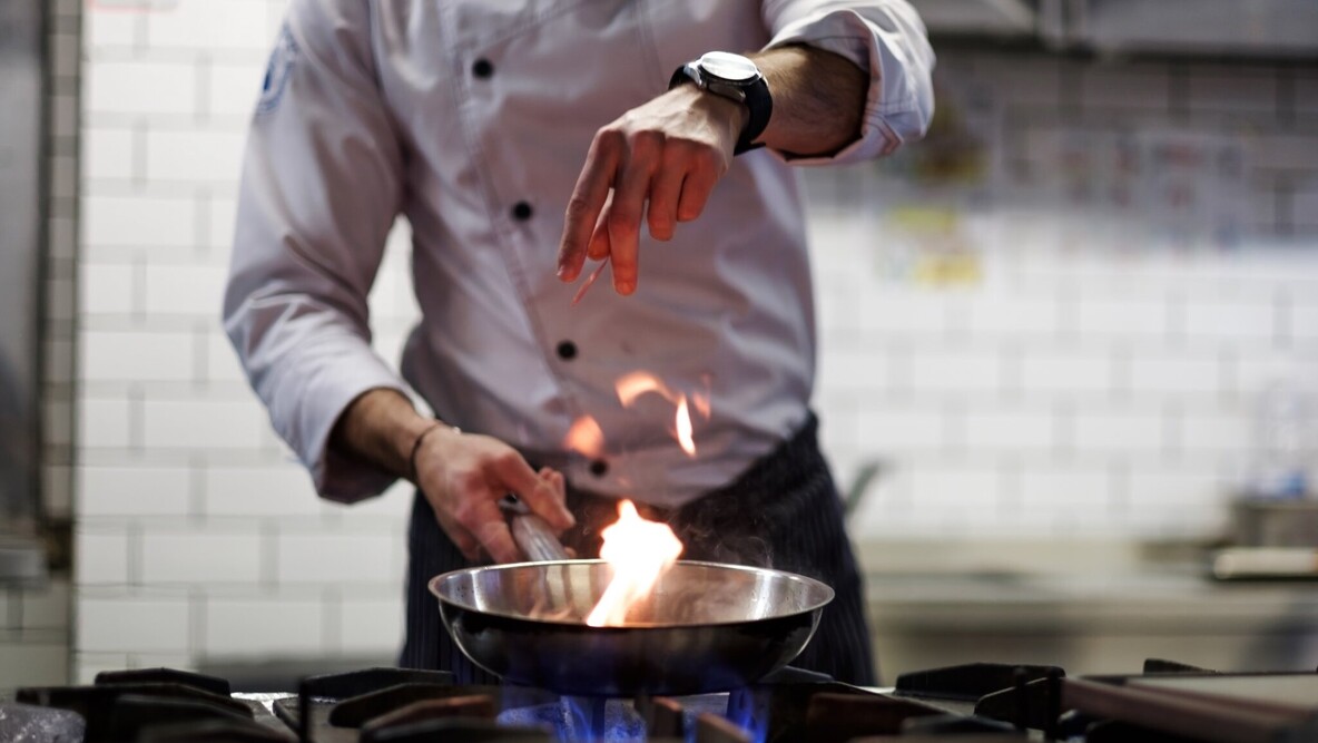 Koch beim kochen mit Flüssiggas an einem Gasherd.
